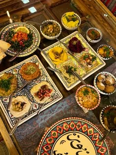 an assortment of food is displayed on plates in a room with wooden walls and flooring