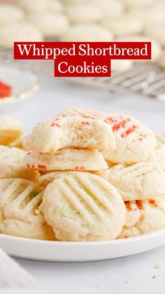 a white plate filled with cookies on top of a table next to other desserts