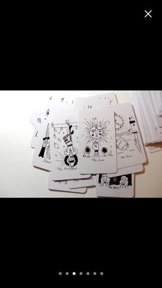 four cards with drawings on them sitting next to each other in front of a window