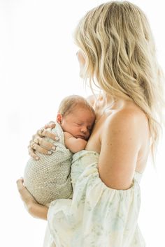 a woman holding a baby in her arms