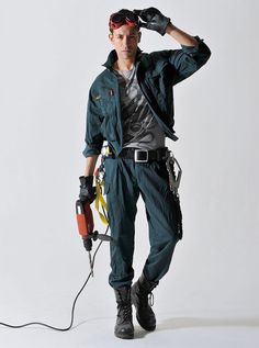 a man in green jumpsuit holding a tool