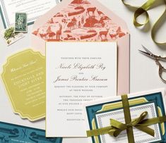 the wedding stationery is laid out on top of each other with ribbon and scissors