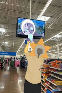 a person is holding up a cartoon character in front of a tv at a store