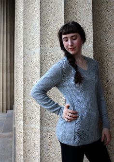 A lightweight cardigan, dress or jumper, and vest in ten sizes (XS/S/M/L/1X/2X/3X/4X/5X/6X) with subtle body shaping that flares below the waist to tunic or knee length. This button-down or pullover style to knit in a plant based blend or fine tweedy wool, is accented by vertical bands of mock cable texture with a touch of openwork. Matching Motifs: Woodfire Scarf, Illas Cies Pullover Suggested Yarns: Modern Deco Lace, Better Breakfast Fingering, Stone Soup Fingering, Shetlandia Fingering, Jacob Elegant Fall V-neck Tunic, Elegant V-neck Tunic For Fall, Casual Stretch Tunic For Fall, Casual Fall Tunic, Casual V-neck Tunic For Fall, Stretch Tunic For Fall, Fitted Long Tops For Layering, Gray Fitted V-neck Cardigan, Fitted Gray Sweater For Spring