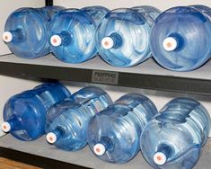 several plastic water bottles lined up on shelves