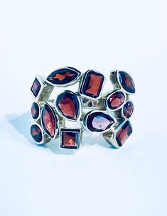 OZAY - The Scarlet - Handmade Sterling Silver Ring with Garnets #jewelry #beautifulbritishcolumbia #jewelrydesigner #bccoast #makersmovement #vanisleartist #inspiredbynature #destinationmarket #finejewelry #shopping #madeinbc #shoponline #shoplocal #artisanjewelry #instajewelry #sterlingsilverjewelry #vancouverislandmarket #sterlingsilver #gemstone #smallbusinesssaturday #vancouverbc #locallymade #islacollective #naturelovers #naturejewelry #craftfair #handmadejewellery #vanislemade #ozayjewel Garnet Meaning, Nature Brand, Pink Sapphire Band, Tiffany Wedding Rings, Dainty Wedding Ring, Alternative Wedding Rings, Latin Word, Early Medieval, Handmade Sterling Silver Rings