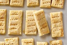 several squares of food sitting on top of a white counter next to other pieces of food