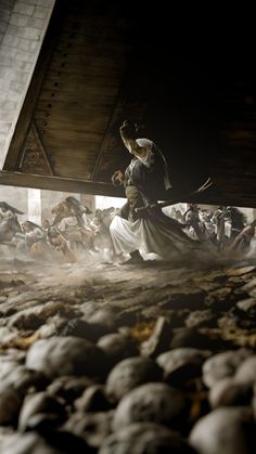 an image of a man standing in the middle of a room with skulls on the floor