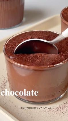 chocolate pudding in a glass dish with a spoon