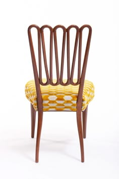 a yellow and brown chair on a white background with the back turned to look like it is