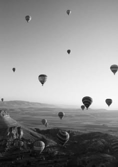 many hot air balloons flying in the sky