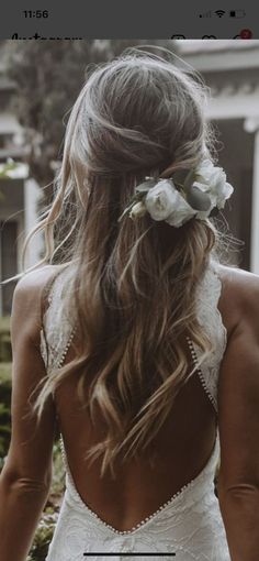 the back of a woman's head with flowers in her hair and text that reads,