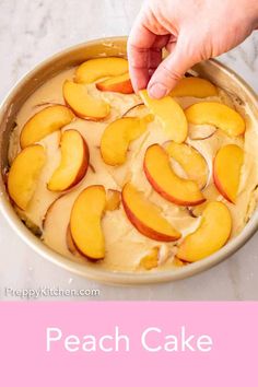 a person is placing peaches on top of a cake in a pan with the words happy kitchen