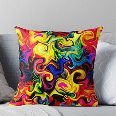 a colorful throw pillow on top of a couch