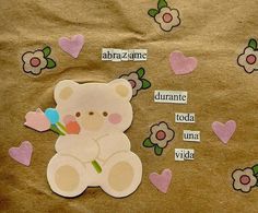 a teddy bear sitting on top of a piece of brown paper with hearts and flowers around it