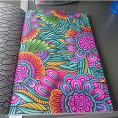 an open notebook with colorful flowers on it