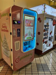 an ice cream vending machine is on display in a store with white tile flooring