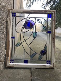 a stained glass window sitting on the side of a building