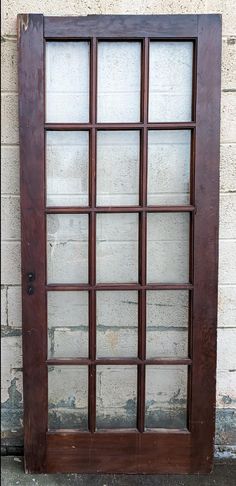 an old wooden window sitting on the side of a building