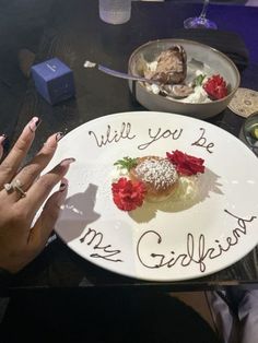 a white plate topped with food on top of a table next to a bowl of fruit