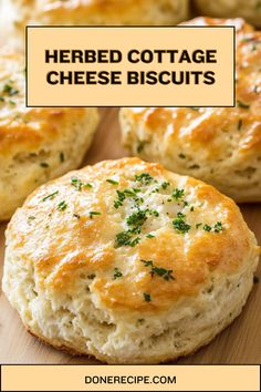 several cheesy biscuits on a cutting board with the words herb cottage cheese biscuits