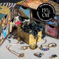 an assortment of jewelry is on display with the sale tag for this item in front