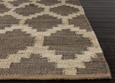 a brown and white rug on top of a wooden floor