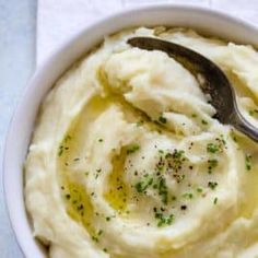 mashed potatoes in a white bowl with a spoon