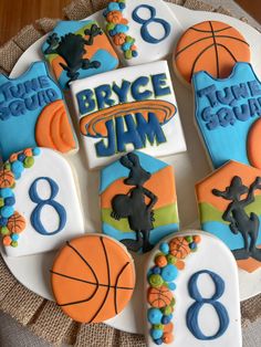 decorated cookies are arranged in the shape of numbers and basketballs on a tablecloth