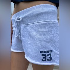 Soft Sweatshorts With 33 Cowboys Print On The Side ,A Thick Elastic Waistband, Raw Hem, And Drawstring. Fabrics: 100% Cotton Measurement: 9" (23 Cm) Rise, 2" (5 Cm) Inseam, 30" (76 Cm) Waist Made In: China Casual Cheerleading Athletic Shorts With Elastic Waistband, Sporty Short Bottoms For Game Day, Cotton Athletic Shorts For Cheerleading, Casual Athletic Shorts For Cheerleading, Casual Cotton Shorts For Cheerleading, Sporty Shorts For Summer Game Day, Sporty Shorts For Game Day In Summer, Brandy Melville Shorts, Side A