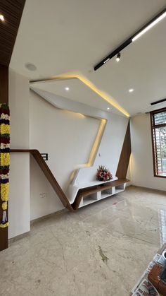 the interior of a house with white walls and marble flooring, decorated with flowers