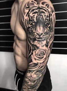 a man with a tiger and roses tattoo on his arm