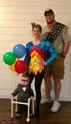 a man, woman and child dressed up in costumes