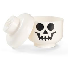 a white cup with a skull face on it