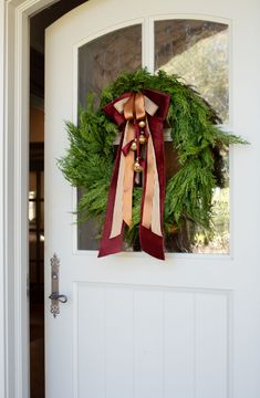 a wreath is hanging on the front door