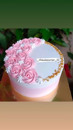 a white and pink cake with flowers on it