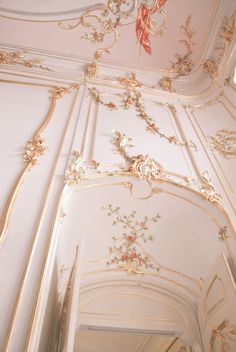 an ornately decorated ceiling in a white room