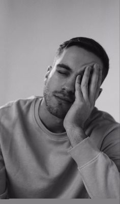 black and white photograph of a man holding his hand to his face