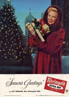 a woman holding presents in front of a christmas tree with the words, season's greetings extra dry