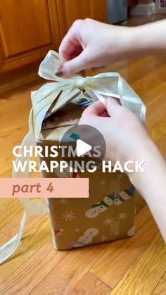 someone wrapping a christmas gift on the floor with white ribbon and text that reads, christmas wrapping hack part 4