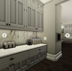 a kitchen with white cabinets and marble counter tops in the middle of an open floor plan