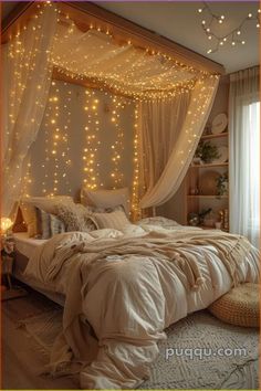 a bed with lights hanging from the ceiling and curtains over it's headboard