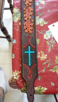 a wooden cross sitting on top of a red chair