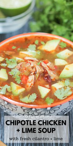 a bowl of chicken and lime soup with cilantro - limes on the side