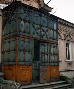 an old building with wooden doors and windows