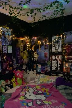 a room with posters and stuffed animals on the walls, lights strung from the ceiling