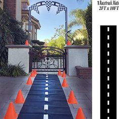 an image of a race track with orange cones on the side and blue carpeted road