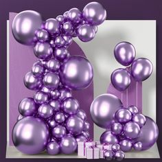 purple balloons and gift boxes in front of a wall