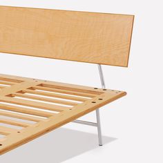 a wooden bed frame sitting on top of a white floor