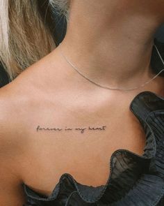 the back of a woman's neck with an inscription that reads, forever is my heart